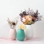 Aesthetic ribbed vases in multiple colors styled with dried and fresh flowers for decorative living space inspiration.