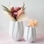 Set of white textured vases of different sizes with dried flowers for chic and aesthetic table decoration.