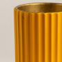 Closeup view of yellow metal vase showcasing fine ribbed detailing and smooth gold base finish for premium craftsmanship.