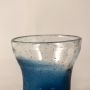 Closeup of blue bubble glass vase showing its handcrafted texture  air bubble detailing  and smooth glossy finish.