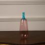 Tall pink glass vase with blue neck and glossy finish perfect for contemporary home or office decoration.