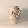 Rustic white chain vase displayed on white background highlighting handcrafted ceramic texture and sculptural design.