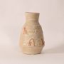 Small hieroglyph vase on white background highlighting intricate carved patterns and smooth handcrafted ceramic finish.