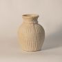 Textured ribbed vase displayed on a clean white background highlighting natural clay finish and handcrafted details.