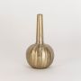 Gold decorative vase shown in styled space without white background for warm ambient interior presentation