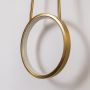 Closeup of gold metal ring wall light showing smooth finish and premium contemporary lighting design.