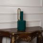 Teal ceramic vase with glossy finish and gold handle displayed on a clean white background ideal for minimal modern interior styling.