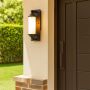 Stylish black metal wall sconce with soft white glow enhancing hallways and living room interiors.
