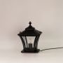 Black metal outdoor pillar lantern with clear textured glass shown on a clean white background for decor display.