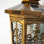A closeup of the bronze outdoor lantern stake light showing the detailed metal scrollwork clear glass panels and warm toned finish ideal for classic exterior decor.