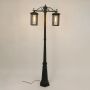 Black metal dual lantern outdoor lamp post light on showing clear glass panels and tall pillar design ideal for driveway pathway garden and exterior Decor.