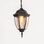 Closeup view of black hanging lantern light showing bulb detail and smooth glass craftsmanship.