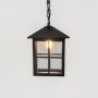 Closeup view of black metal hanging lantern showing bulb detail and geometric frame design.
