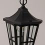 Closeup view of black metal outdoor lantern with clear glass panels highlighting detailed frame for modern outdoor decor.