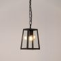 Matte black metal hanging lantern light glowing softly with clear glass design perfect for outdoor walls and modern entrances.