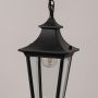 Closeup view of black metal hanging lantern with clear glass panels highlighting its classic outdoor lighting design.