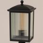 Closeup of black outdoor post light with ribbed glass panels highlighting its sturdy build and elegant design.