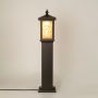Brown outdoor pillar lamp with Chinese pattern frosted glass shown with light on against a white background highlighting its warm glow and ornate design.