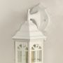 Closeup of white outdoor lantern highlighting the arched glass panels bright white metal frame and classic lantern shape perfect for stylish entrances.