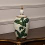 Elegant white ceramic jar with green leaf pattern and gold accent lid perfect for modern luxury home styling.
