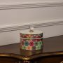 Round ceramic jar with multicolor geometric flower pattern and crystal knob lid perfect for elegant home interiors.